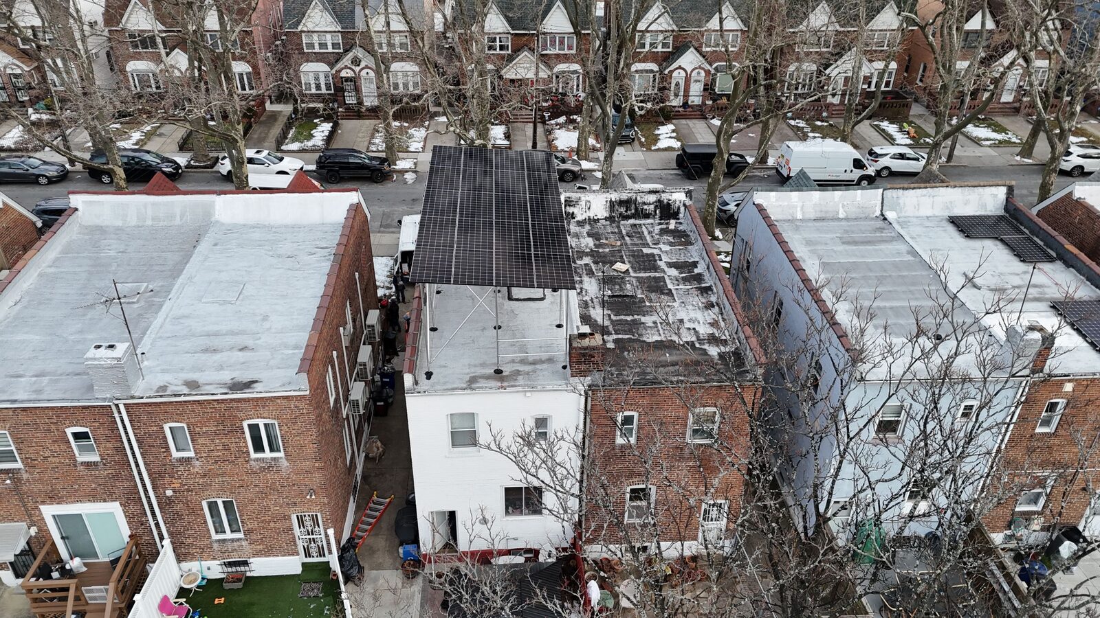 Elevated tilt-rack solar canopy on a New York roof