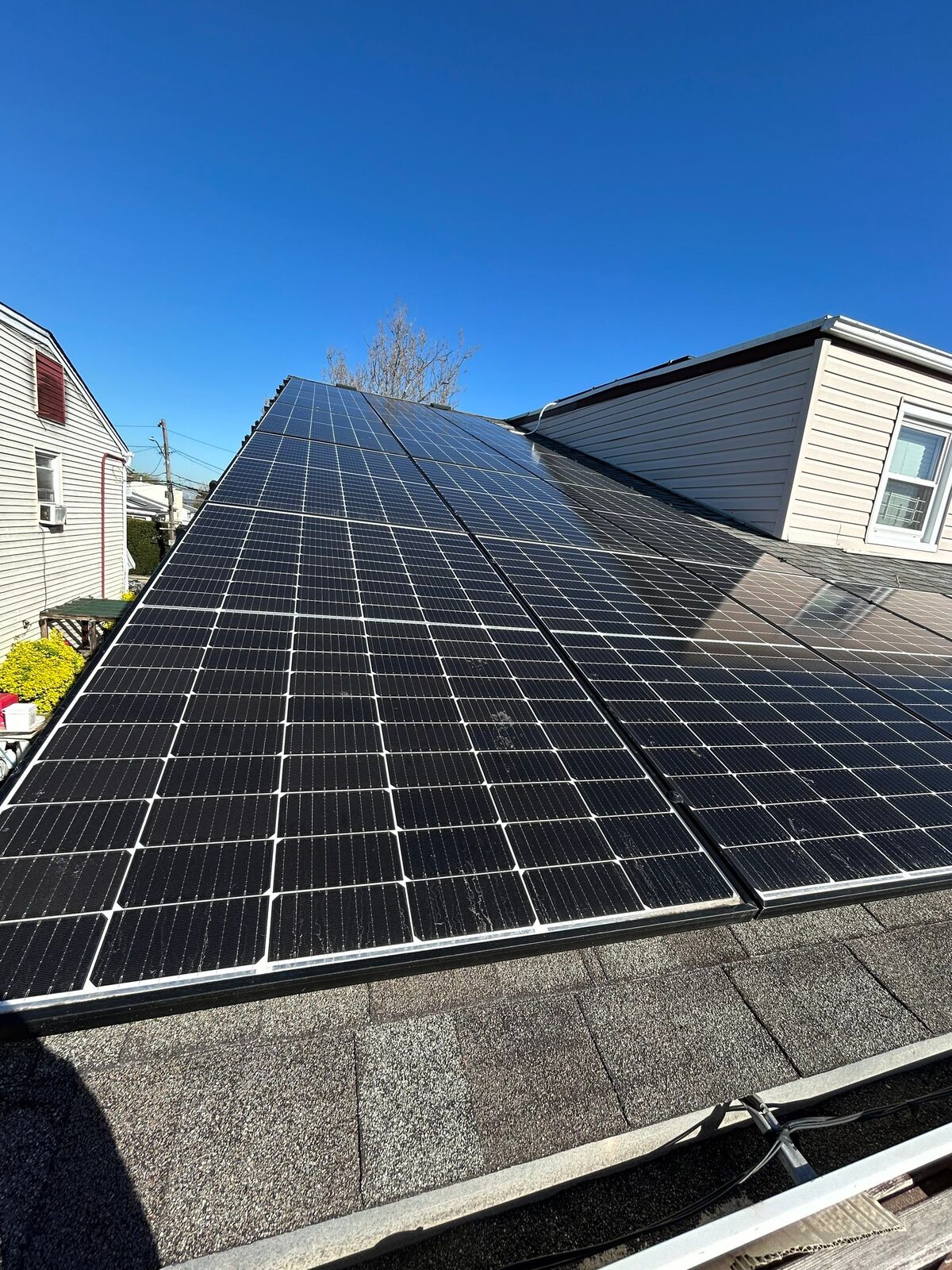 Close-up of level, true black-glass solar panels on a New York roof