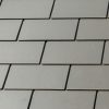 roof-repair-worker-with-white-gloves-replacing-gray-tiles-shingles-house-with-blue